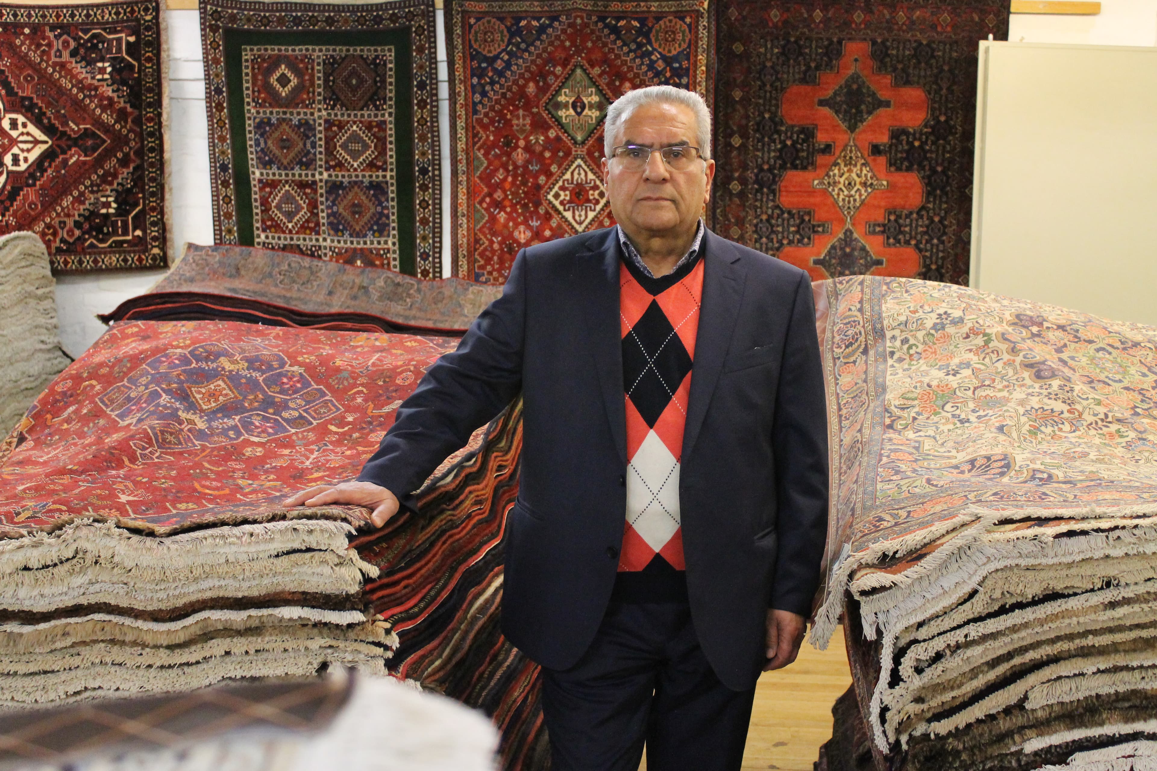 Mr. Mohammad Khani in the showroom with handknotted carpets